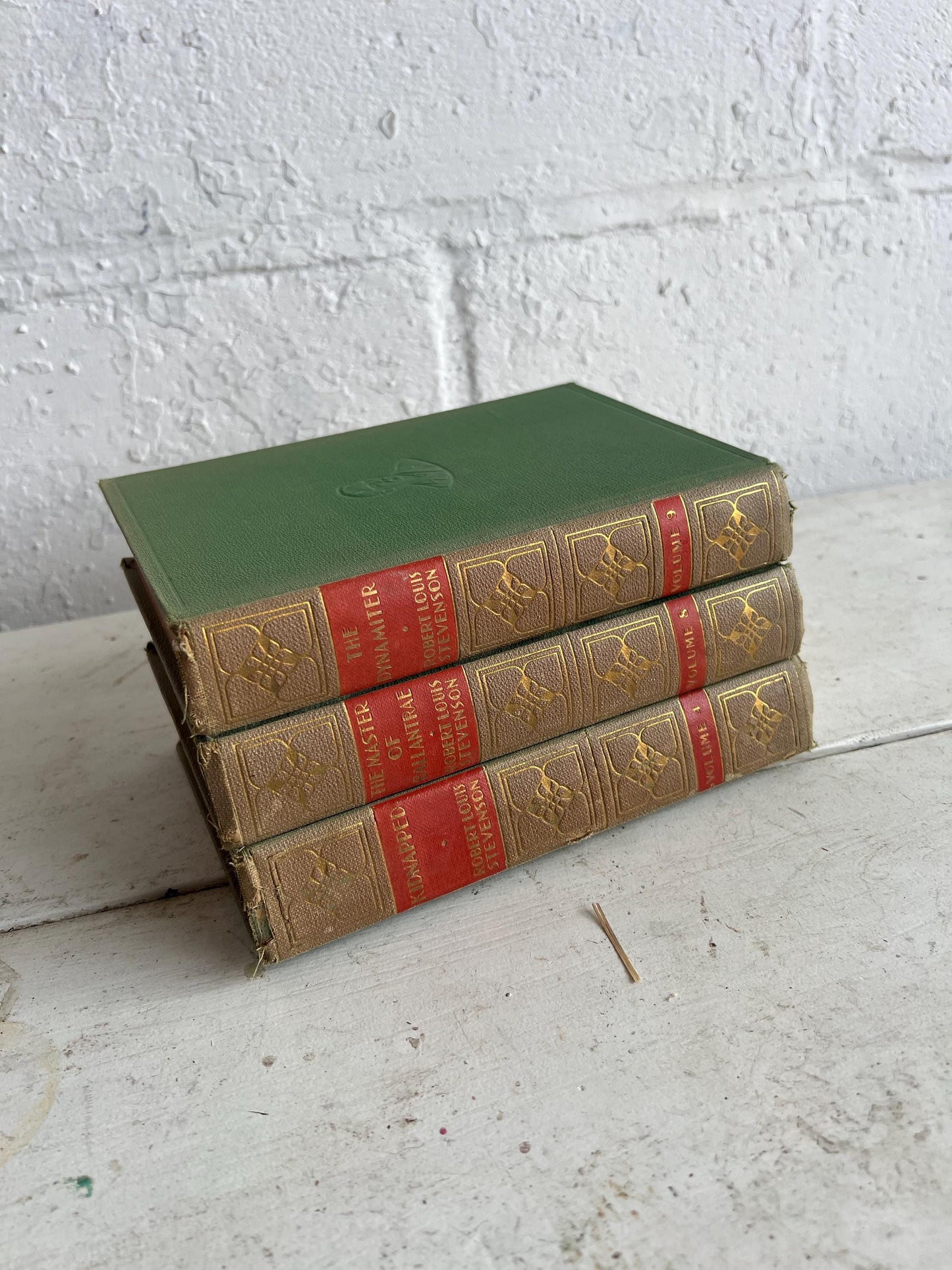 VINTAGE BOOK STACK | vintage green with red & gold accents, Robert Louis Stevenson, table styling, old books, coffee table books
